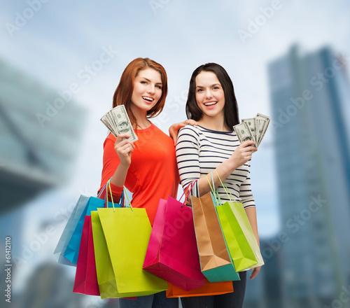 Photo: smiling teenage girls with shopping bags and money smiling teenage girls with shopping bags and money
