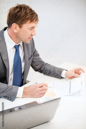 Photo: businessman with laptop computer and documents businessman with laptop computer and documents