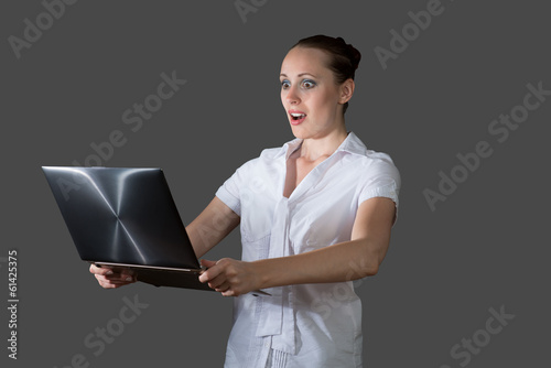 Photo: business woman holding a laptop business woman holding a laptop