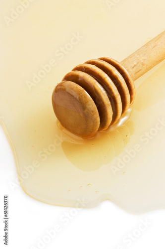 Photo: honey and stick on white honey and stick on white