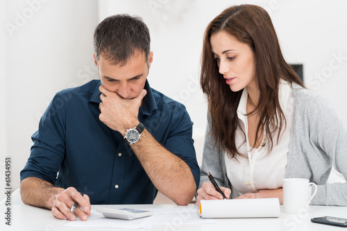 Photo: Couple Calculating Budget Couple Calculating Budget