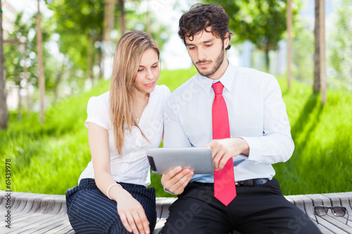 Photo: Business people using a digital tablet Business people using a digital tablet