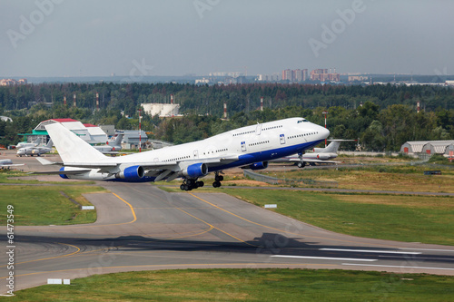 white plane takes off from the runway