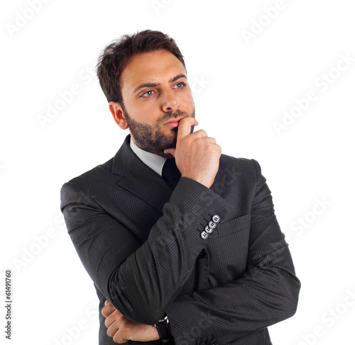 Photo: Young businessman thinking and reflecting. Young businessman thinking and reflecting.