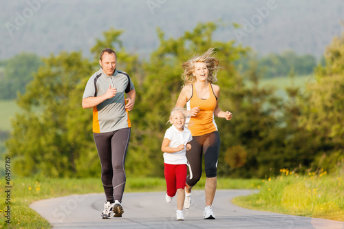 Photo: Familie joggt in der Natur für Sport Fitness Familie joggt in der Natur für Sport Fitness