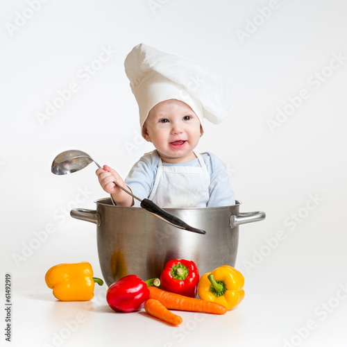 Photo: cook baby sitting inside pan with healthy food cook baby sitting inside pan with healthy food