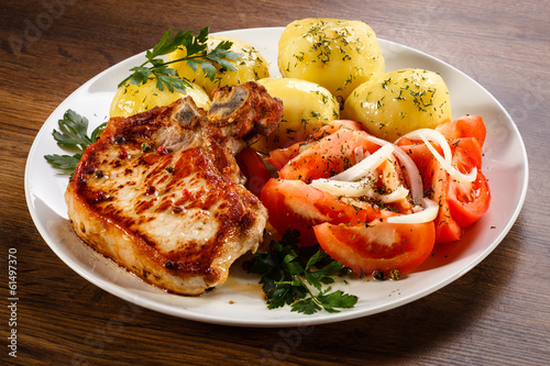 Photo: Grilled steak, boiled potatoes and vegetable salad Grilled steak, boiled potatoes and vegetable salad