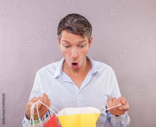 Photo: surprised shopping man surprised shopping man