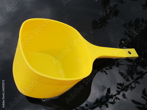Photo: Plastic water dipper floating in the barrel Plastic water dipper floating in the barrel