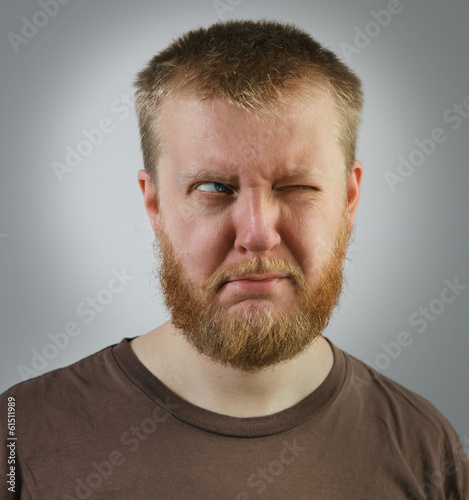 Photo: Man looking off to the side with one eye Man looking off to the side with one eye