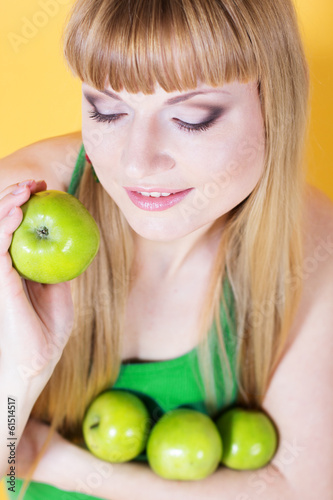 Photo: Happy blonde girl with green apples Happy blonde girl with green apples