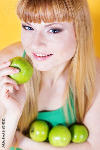 Photo: Happy blonde girl with green apples Happy blonde girl with green apples
