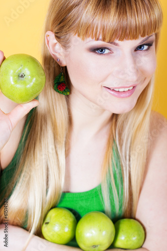 Photo: Happy blonde girl with green apples Happy blonde girl with green apples