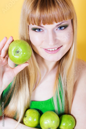 Photo: Happy blonde girl with green apples Happy blonde girl with green apples