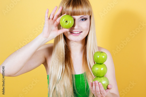 Photo: Happy blonde girl with green apples Happy blonde girl with green apples