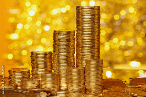 Photo: Coins stack on golden bokeh background Coins stack on golden bokeh background