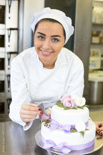 Photo: Baker decorates a cake with food dye Baker decorates a cake with food dye