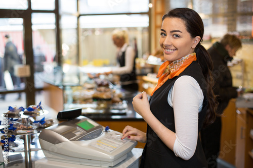 Photo: Salesperson at cash register Salesperson at cash register