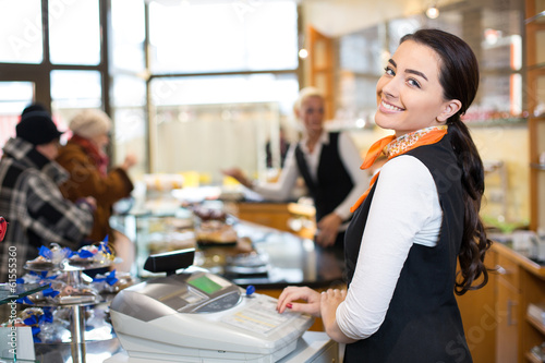 Photo: Salesperson at cash register Salesperson at cash register
