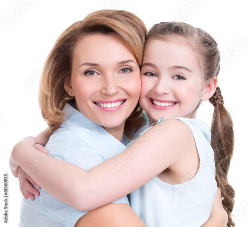 Photo: Closeup portrait of happy mother and young daughter Closeup portrait of happy mother and young daughter