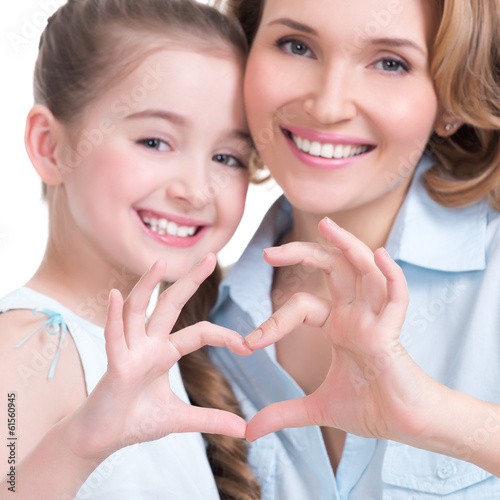 Photo: mother and young daughter with heart shape sign mother and young daughter with heart shape sign