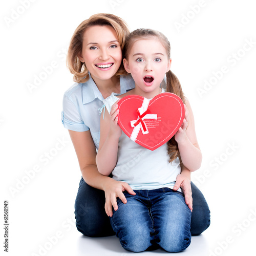 Photo: happy mother and young daughter hold gift for birthday happy mother and young daughter hold gift for birthday