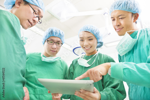 Photo: happy Surgeons discussing success operating procedure happy Surgeons discussing success operating procedure