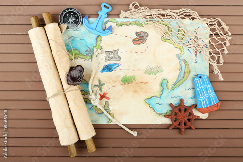 Photo: Treasure map with sea accessories, on wooden background Treasure map with sea accessories, on wooden background