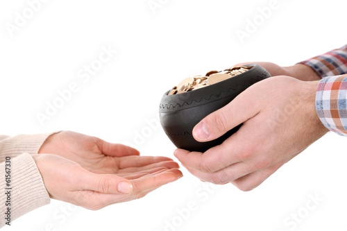 Photo: Ceramic pot with golden coins in male and female hands, Ceramic pot with golden coins in male and female hands,