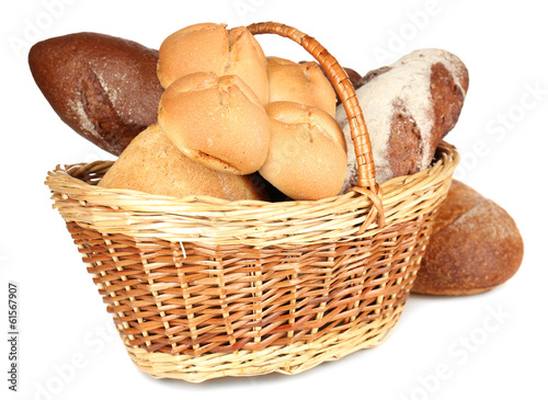 Photo: Composition with bread and rolls in wicker basket isolated Composition with bread and rolls in wicker basket isolated