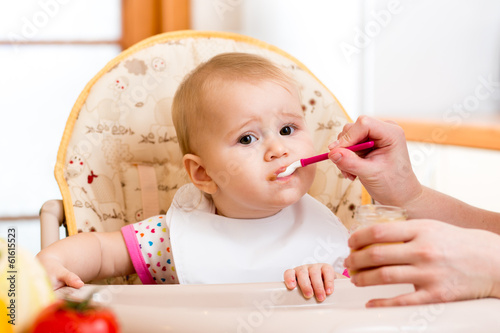 Photo: baby eating food on kitchen baby eating food on kitchen