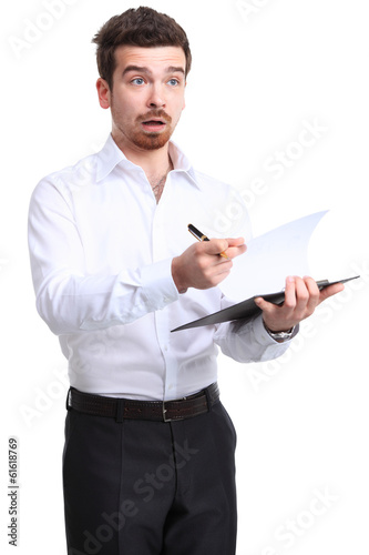 Photo: Portrait of cheerful businessman making notes and looking at cam Portrait of cheerful businessman making notes and looking at cam
