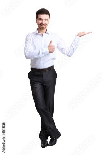 Photo: Business man presenting over a white background Business man presenting over a white background