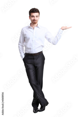Photo: Business man presenting over a white background Business man presenting over a white background