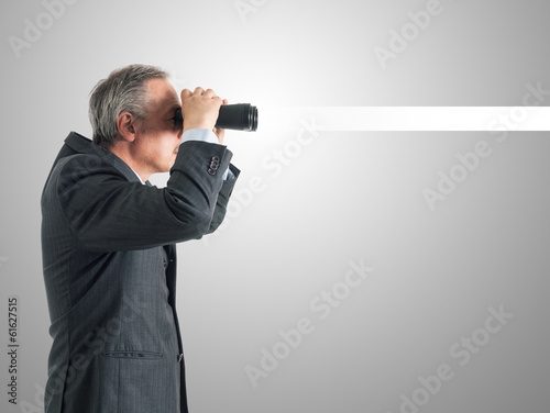 Photo: Businessman using binoculars Businessman using binoculars
