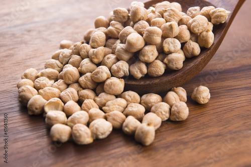 Photo: dried white chickpeas ceci on the wooden spoon dried white chickpeas ceci on the wooden spoon