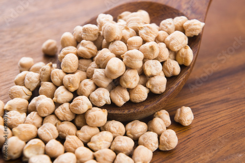 Photo: dried white chickpeas ceci on the wooden spoon dried white chickpeas ceci on the wooden spoon