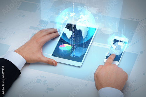 Photo: businessman working with table pc and smartphone businessman working with table pc and smartphone