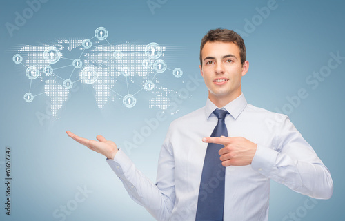 Photo: man showing map and network on the palm of hand man showing map and network on the palm of hand