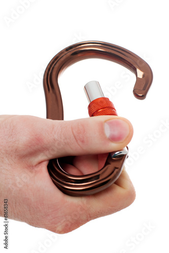 Photo: Male hand holding climbing carabiner Male hand holding climbing carabiner