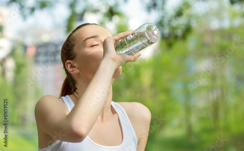 Photo: Vitality woman drinking water, outdoor - park - forest Vitality woman drinking water, outdoor - park - forest