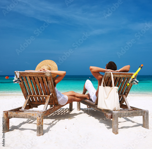 Photo: Couple with inflatable rafts looking at seaplane on beach Couple with inflatable rafts looking at seaplane on beach