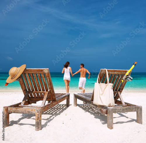 Photo: Couple with inflatable rafts looking at seaplane on beach Couple with inflatable rafts looking at seaplane on beach