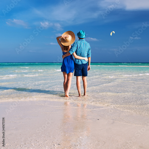 Photo: Couple with inflatable rafts looking at seaplane on beach Couple with inflatable rafts looking at seaplane on beach
