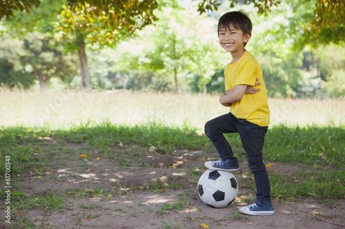 Photo: Cute little boy with football at park Cute little boy with football at park