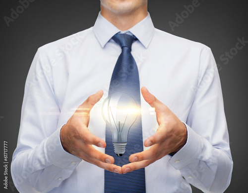 Photo: buisnessman holding something in his hands buisnessman holding something in his hands