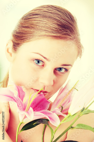 Photo: Beautiful blond woman with lily flower Beautiful blond woman with lily flower