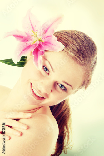 Photo: Beautiful blond woman with lily flower Beautiful blond woman with lily flower