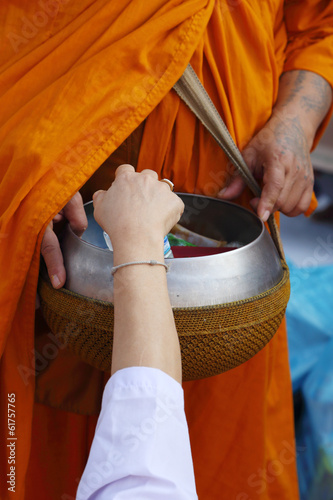 Photo: Hand put food offerings in a Buddhist monk's alms bowl Hand put food offerings in a Buddhist monk's alms bowl