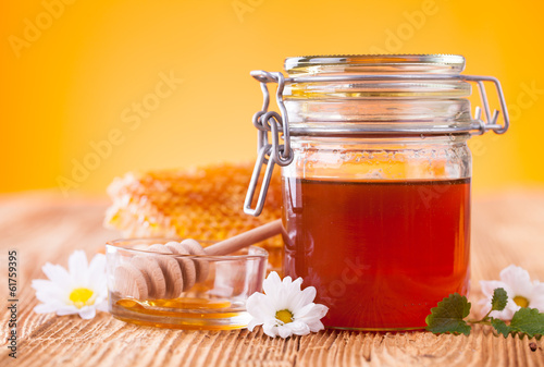 Photo: Still life of honey on wooden table Still life of honey on wooden table